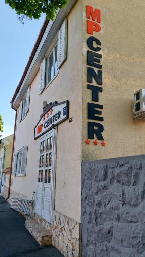a building with a sign on the side of it at MP Center Magánszállás in Miskolc
