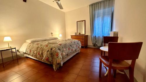 een slaapkamer met een bed en een tafel en stoelen bij Dreaming Assisi Apartment in Assisi