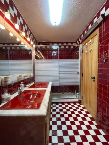 a bathroom with a red sink and a checkered floor at Sesimbra Retreat by the Sea in Sesimbra
