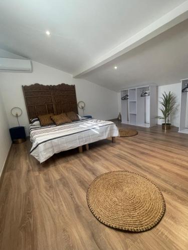 a bedroom with a large bed and a wooden floor at Villa Frescati in Vence