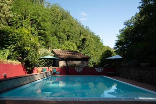 a swimming pool in the backyard of a house at Mulino di Castelvecchio in Borgo a Buggiano
