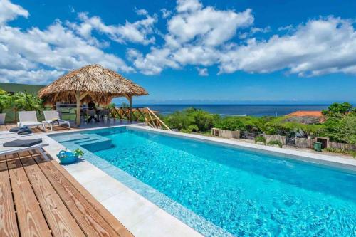 a swimming pool with a view of the ocean at Villa Vista Valentin in Willemstad