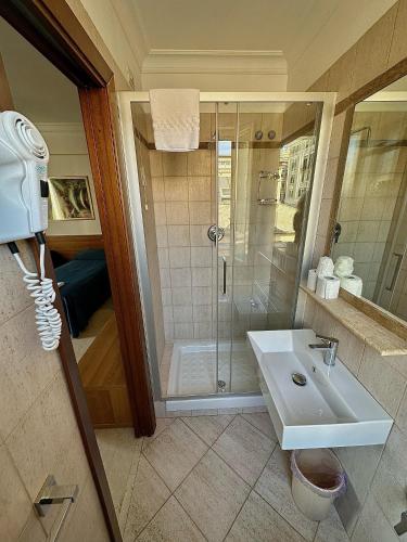 a bathroom with a shower and a sink at Hotel Principe Di Piemonte in Rome