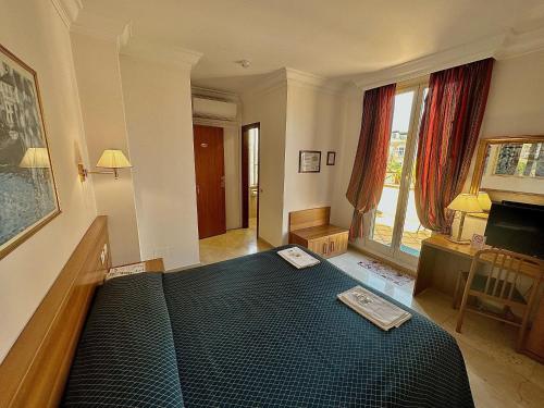 a bedroom with a bed with a black comforter at Hotel Principe Di Piemonte in Rome