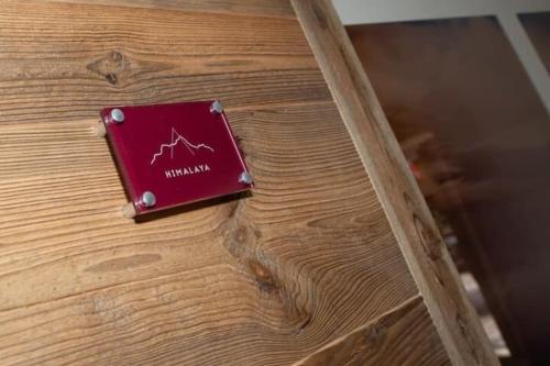 a red book sitting on top of a wooden table at HIMALAYA Annecy Rent Lodge in Annecy
