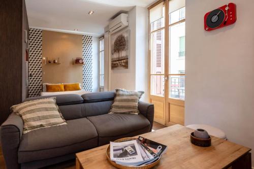 a living room with a couch and a table at ANNAPURNA Annecy Rent Lodge in Annecy