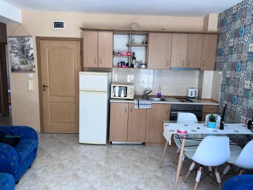 a kitchen with a white refrigerator and a table with chairs at Sunny Beach Apartment - Kuban / Bravo 5 in Sunny Beach