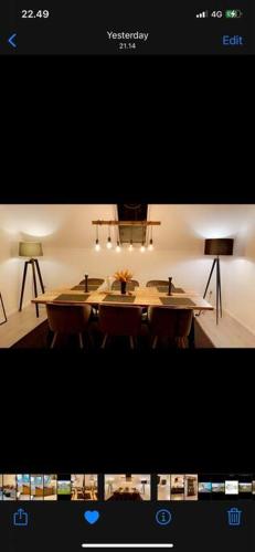 a picture of a dining room with a table and two lamps at Big villa in stege near møns klint with trampolin in Stege