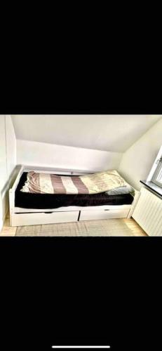 a small bed in the corner of a room at Big villa in stege near møns klint with trampolin in Stege