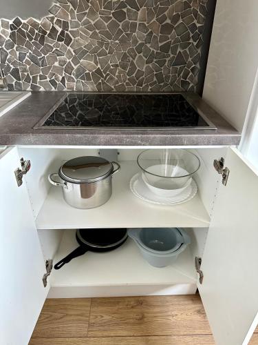 a kitchen drawer with a sink and pots and pans at Cosy place in small town in Maardu