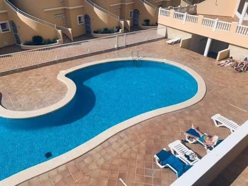 a large swimming pool in the middle of a building at Residencial Benimar Licencia Vv in Adeje
