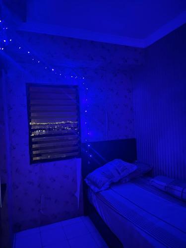 a bedroom with purple lights and a bed at Apartemen Casablanca 2Br in Jakarta