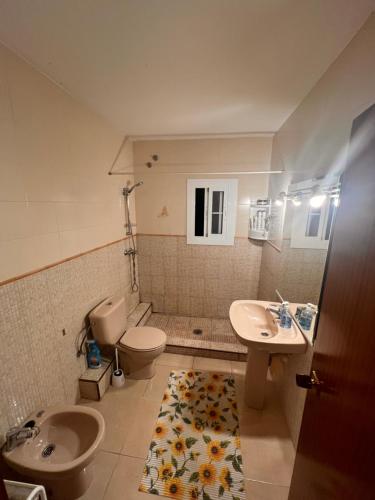 a bathroom with a toilet and a sink and a toilet at Playa home in Cunit