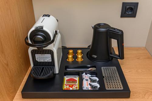 a coffee maker on top of a table at HOTEL CENTRAL Pascani in Paşcani
