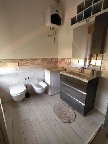 uma casa de banho com um lavatório, um WC e uma banheira e um lavatório. em Miky's House em Teulada
