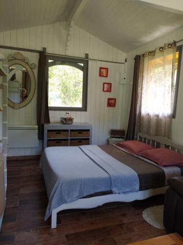 a bedroom with a large bed and a window at Chambre d hôte dans un magnifique chalet in Pontenx-les-Forges