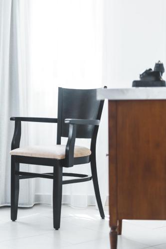 a black chair sitting in front of a desk at Zeus Village Resort - Adults Only in Kato Daratso