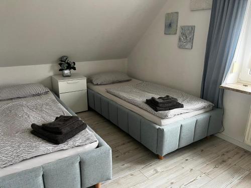 a bedroom with two beds with towels on them at Deichblick in Brunsbüttel