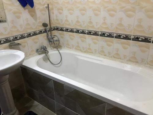 a bathroom with a bath tub and a sink at Maliaways Comfy Airbnb-Jkia in Nairobi