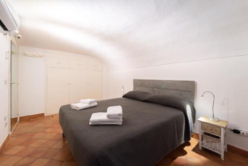 ein Schlafzimmer mit einem Bett mit zwei Handtüchern darauf in der Unterkunft Claudia's home 2 in Alghero