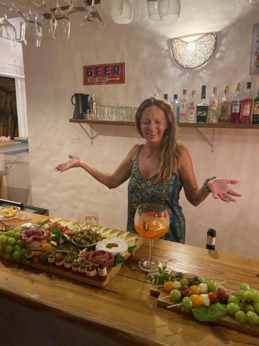 a woman standing in front of a counter with food at Hotel La Tortuga in Las Terrenas