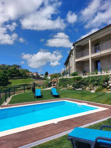 a swimming pool in the yard of a house at Casa da Carreira in Mondim de Basto