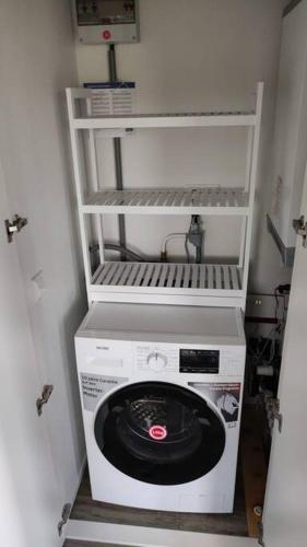 a washer and dryer in a small room at Chalet Seepark Süsel in Süsel
