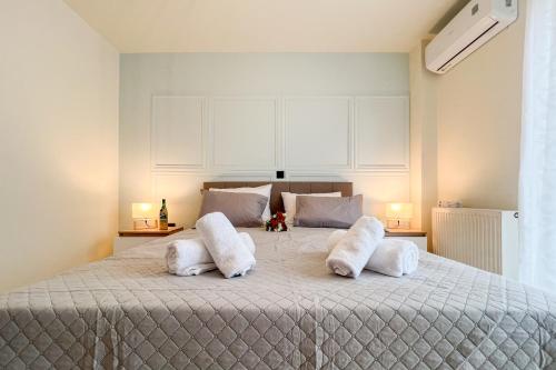 a bedroom with a large bed with white pillows at Saint Georgio Castle View Villa in Argostoli
