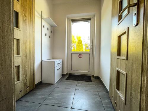 a hallway with a door and a window at Agroturystyka"u Piwowara" in Kłodzko