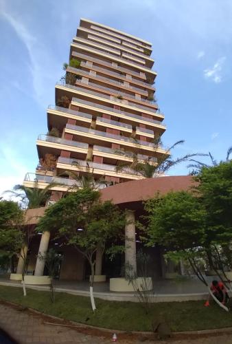 a tall building with trees in front of it at Sea View Studio at Oasis in Chakvi