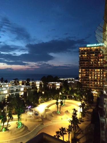 a view of a city at night with a building at Sea View Studio at Oasis in Chakvi