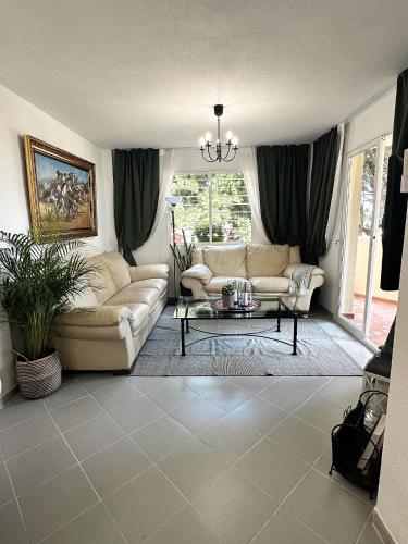a living room with a couch and a table at Art-Apart Caronte in Riviera del Sol, Mijas Costa in Mijas Costa