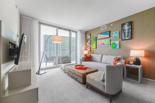 a living room with a couch and a table at Gorgeous Views Await in Your Beachfront Condo in Hollywood