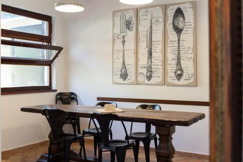 a dining room with a wooden table and chairs at Claudia's home 2 in Alghero