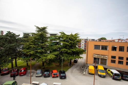 a group of cars parked in a parking lot at Downtown Labin in Labin