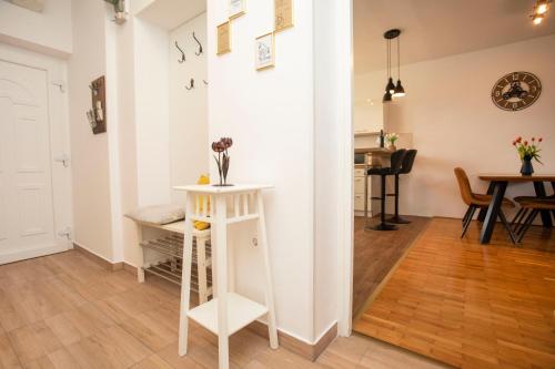 a living room with a white wall and a table at Downtown Labin in Labin