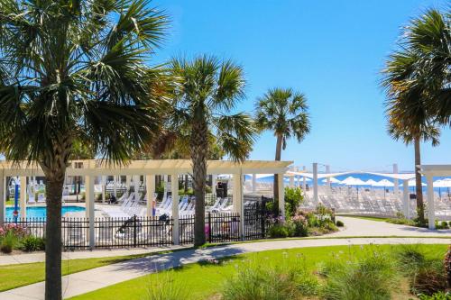a resort with palm trees and a pool at Whispering Palms in Seabrook Island