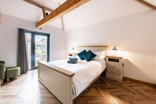 a bedroom with a large bed and a window at Willow Barn in Haddiscoe