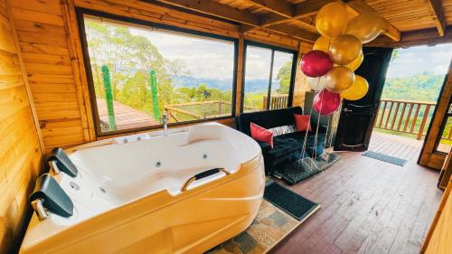 a tub in a room with balloons and balloons at Glamping Magic Love in San Francisco