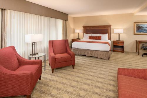 a hotel room with a bed and a chair at The Inn at Virginia Tech - On Campus in Blacksburg