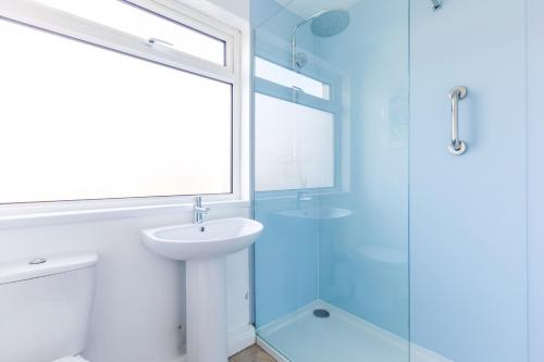 a bathroom with a sink and a glass shower at Bella Vista in Polzeath