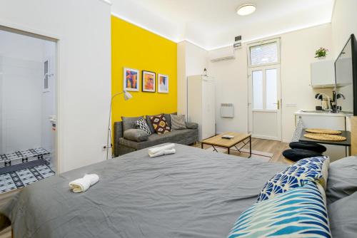 A bed or beds in a room at Stylish yellow suite in the heart of Budapest