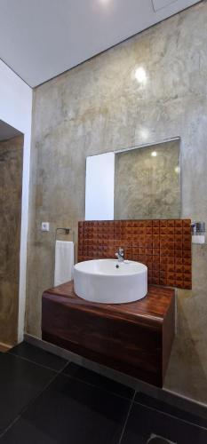 a bathroom with a sink and a mirror at A-Típica GuestHouse in Ponta Delgada