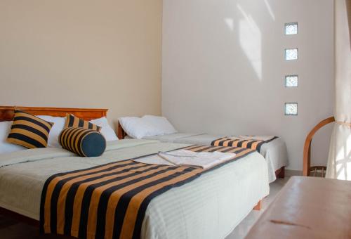 Postel nebo postele na pokoji v ubytování Hillcrest Haputale