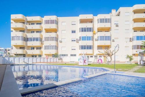 a building with a swimming pool in front of a building at Solbelo Quarteira Beach in Quarteira