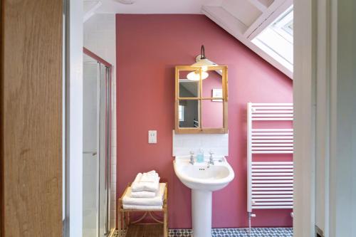 a bathroom with a sink and a pink wall at The Buttery in Freston