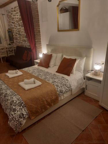 a bedroom with a bed with two towels on it at Old Town Rab Studio apartment in Rab