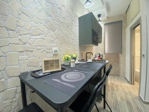 a kitchen with a table with a laptop on it at Guest Amatur in Ercolano