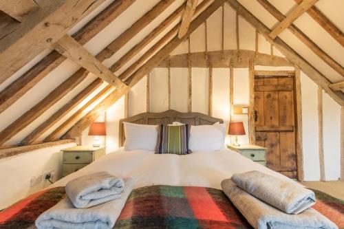 a bedroom with a bed with two towels on it at Mill House in East Dereham