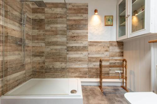 a bathroom with a tub and a glass shower at Host & Stay - Mill House in East Dereham